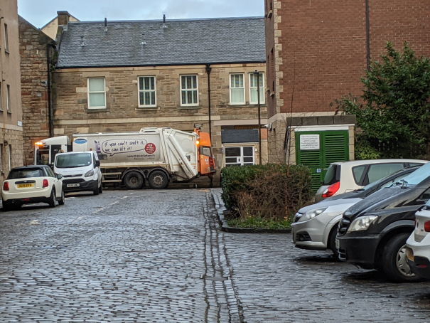 "A bin lorry collecting the rubbish the next day"